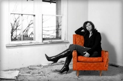 Robyn sitting in an orange chair